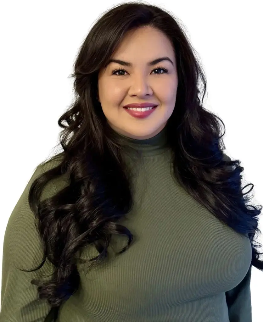 A woman with long black hair wearing a green shirt.